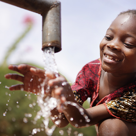 girl getting water from well